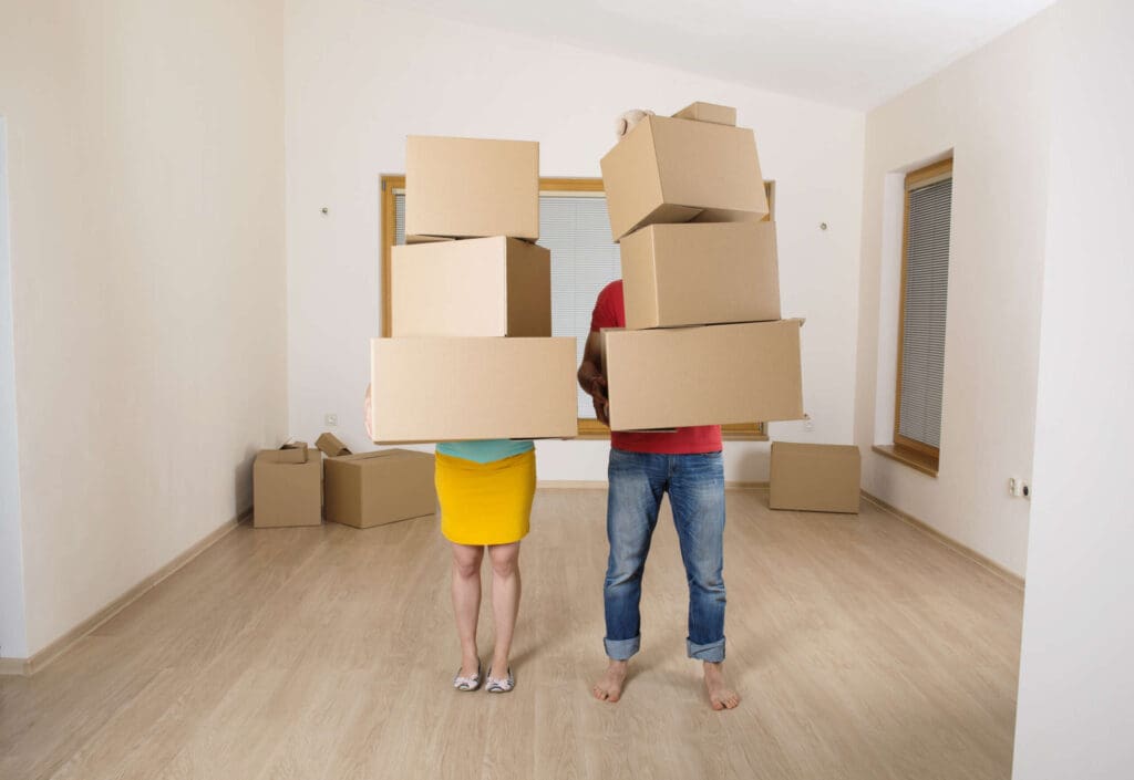 Young couple is moving into new house with lot of boxes.