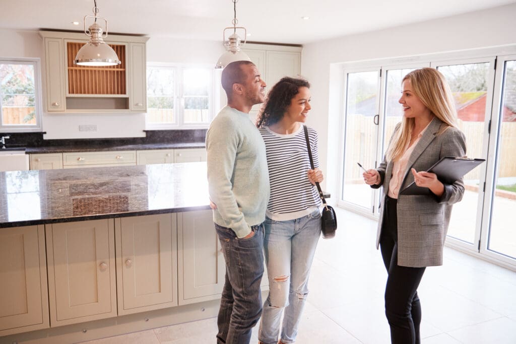 Realtor Showing Couple Interested In Buying Around House