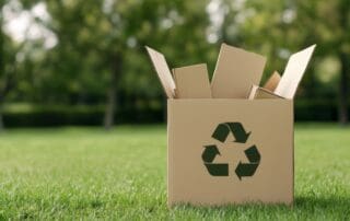 A recycling box filled with cardboard packaging, symbolizing the importance of eco-friendly packaging and the move toward a circular economy.