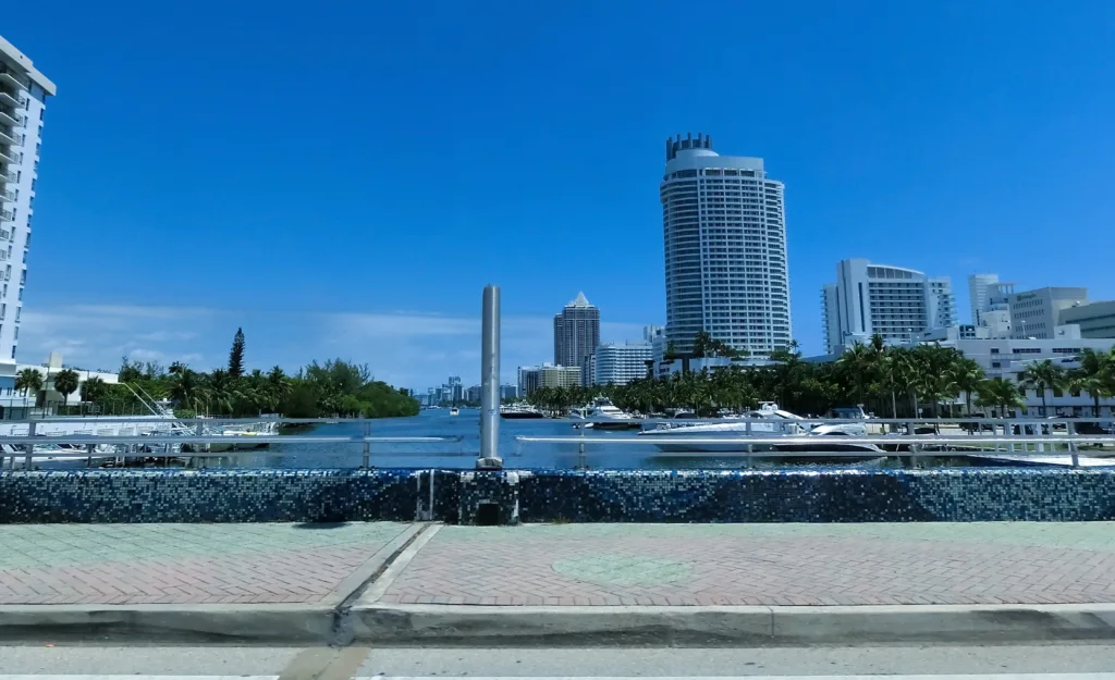 South Florida Fort Lauderdale skyline with palm trees, blue ocean, and sunny skyline representing the service area for Sorensen Moving and Storage