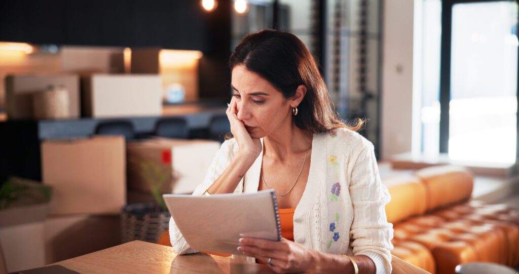 Concern, woman and reading document at new house for property purchase, agreement and hidden fees. Worry, female person and contract with legal terms, lease cost and review information for relocation