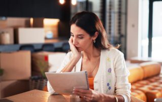 Concern, woman and reading document at new house for property purchase, agreement and hidden fees. Worry, female person and contract with legal terms, lease cost and review information for relocation